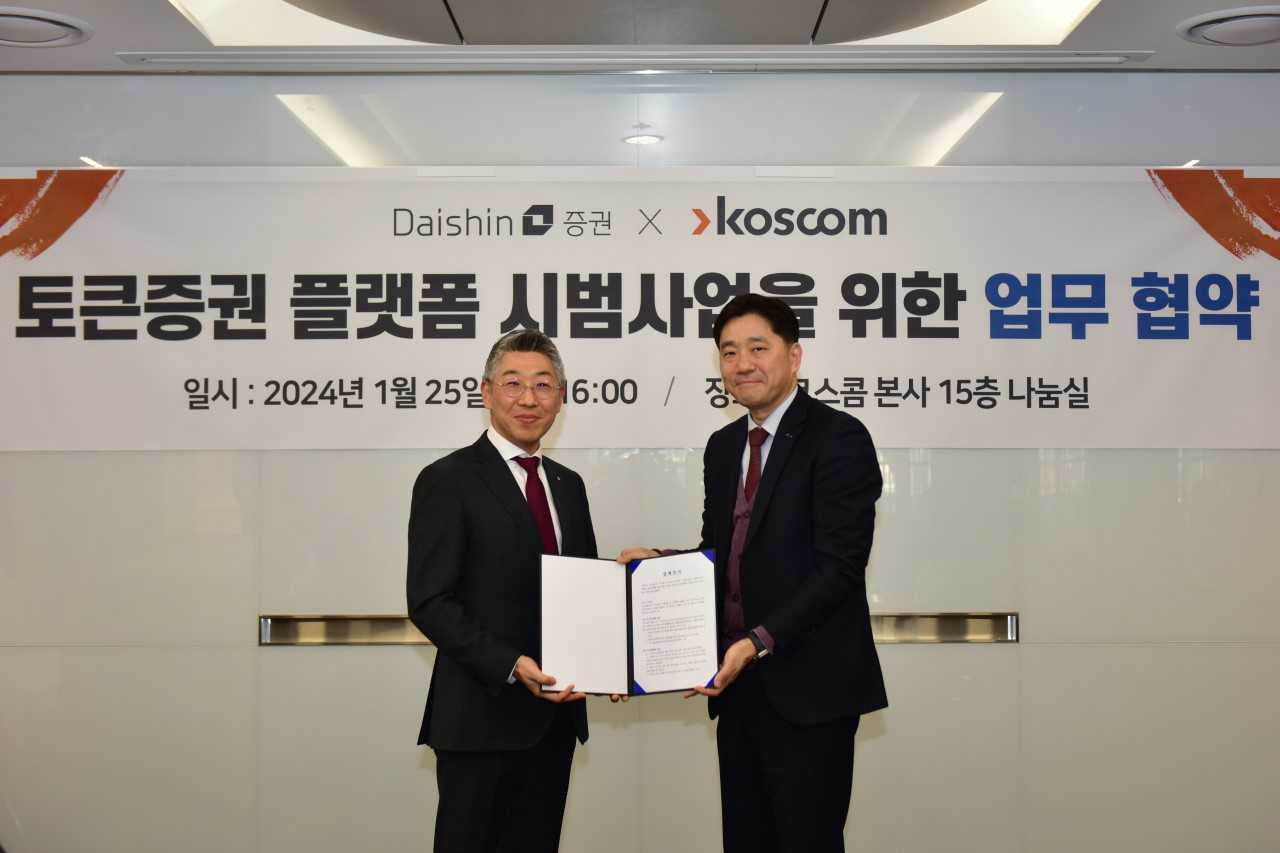 송종원 대신증권 경영기획부문장(좌측)과 김성환 코스콤 디지털사업본부장(우측)이 지난 25일 토큰증권 플랫폼 업무 협약 체결 후 기념 촬영을 하고 있다. [대신증권]