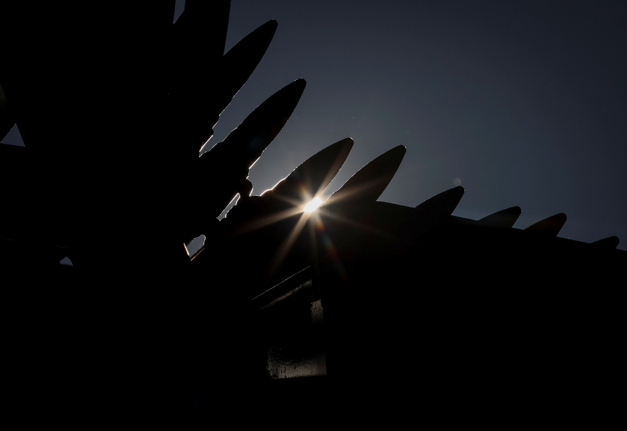 Sun rays shine through the cartridges of a machine gun belt, amid Russia's attack on Ukraine, near Kyiv, Ukraine on Monday. (Reuters)