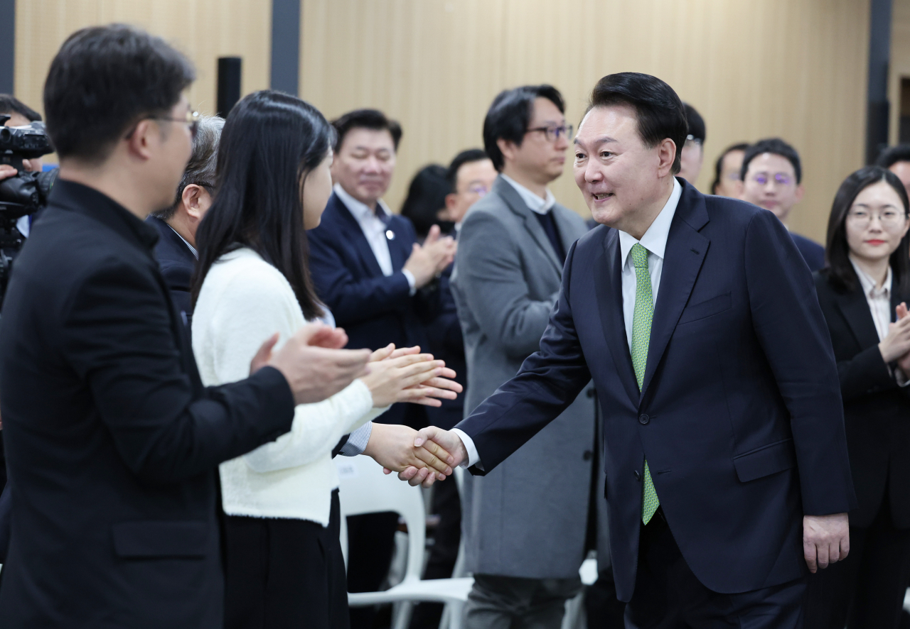윤석열 대통령이 30일 경기도 성남시 판교제2테크노밸리기업지원허브에서 열린 '국민과 함께하는 민생토론회- 일곱번째, 상생의 디지털, 국민권익 보호'에 입장하며 참석자들과 악수하고 있다. [연합]