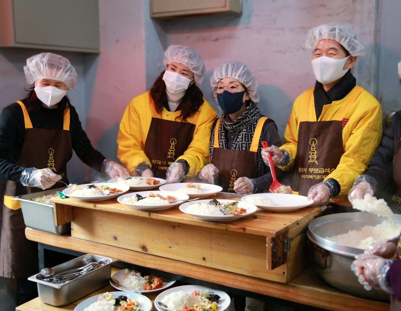 아성다이소 임직원들이 지난 31일 저소득 노인과 노숙인들을 대상으로 제공하는 무료점심을 배식하고 있다. [아성다이소 제공]
