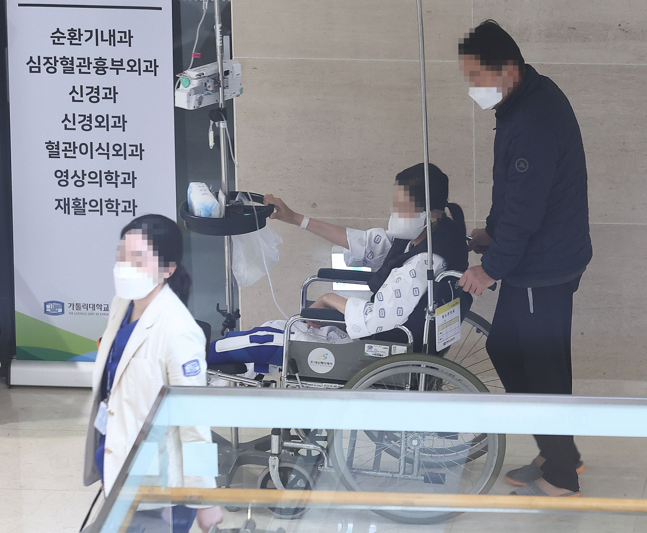 정부의 의대 정원 확대 정책에 반대하는 의사들이 설을 쇠자마자 집단행동에 나섰다. 사진은 지난 12일 서울의 한 대학 병원에서 의료진과 환자가 이동하는 모습[연합]