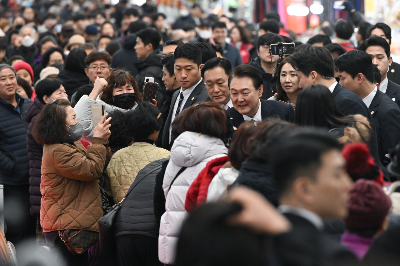 윤석열 대통령이 지난 22일 경남 창원시 마산합포구 마산어시장을 찾아 시민들과 인사하고 있다. [연합]