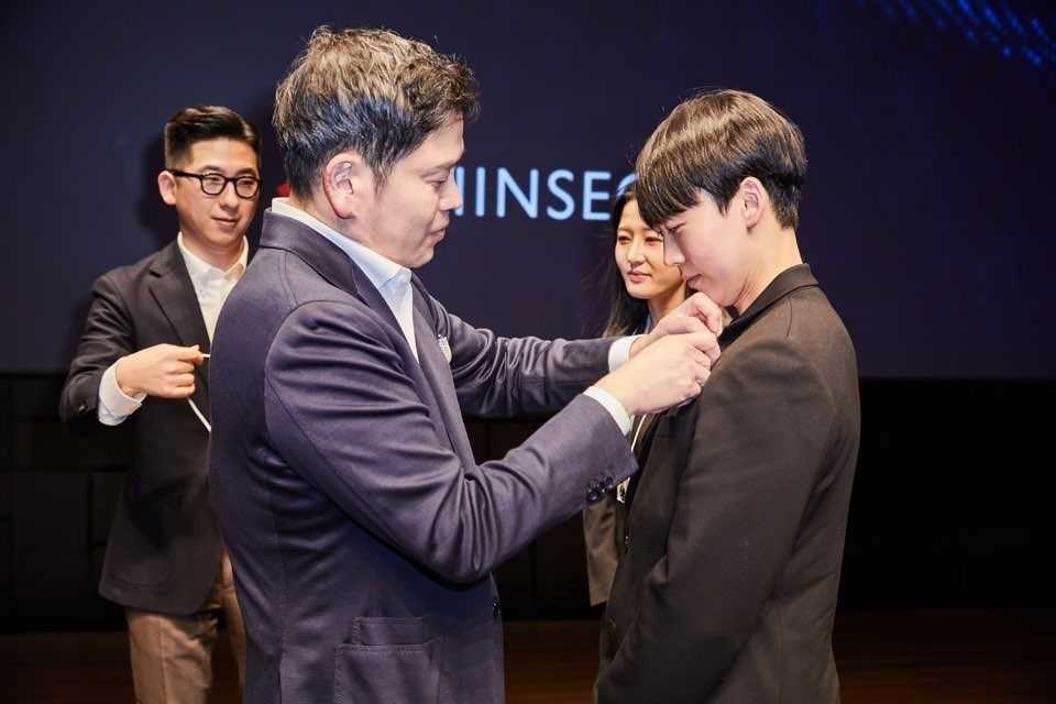 정용진 신세계그룹 부회장이 ‘신세계 남산’에서 열린 신입사원 그룹 입문교육 수료식에서 신입사원에게 사원증을 걸어주고 있다. [신세계그룹 제공]