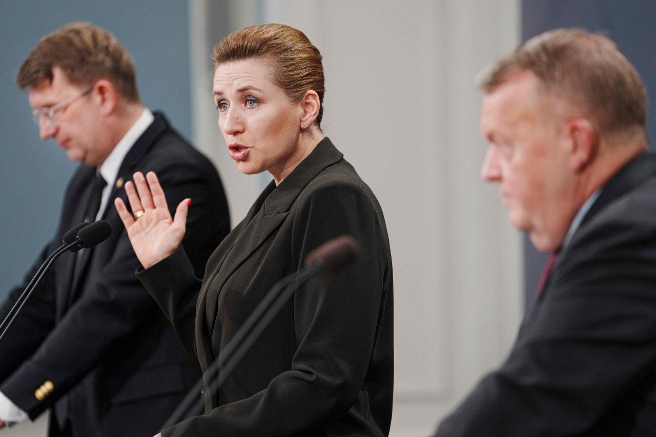 Denmark's Prime Minister Mette Frederiksen (center), Deputy Prime Minister and Minister of Defense Troels Lund Poulsen (left) and Foreign Minister Lars Loekke Rasmussen participate in a press conference on strengthening the Armed Forces, on Wednesday, in Copenhagen. (AFP)
