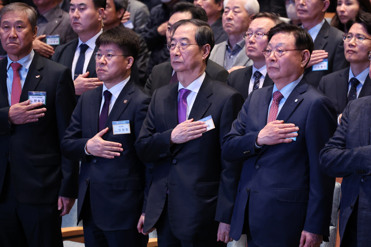 한덕수(앞줄 오른쪽 두번째) 국무총리가 25일 오후 서울 강남구 건설회관에서 열린 건설기술인의 날 기념식에 참석해 내빈들과 국기에 경례하고 있다. [연합]