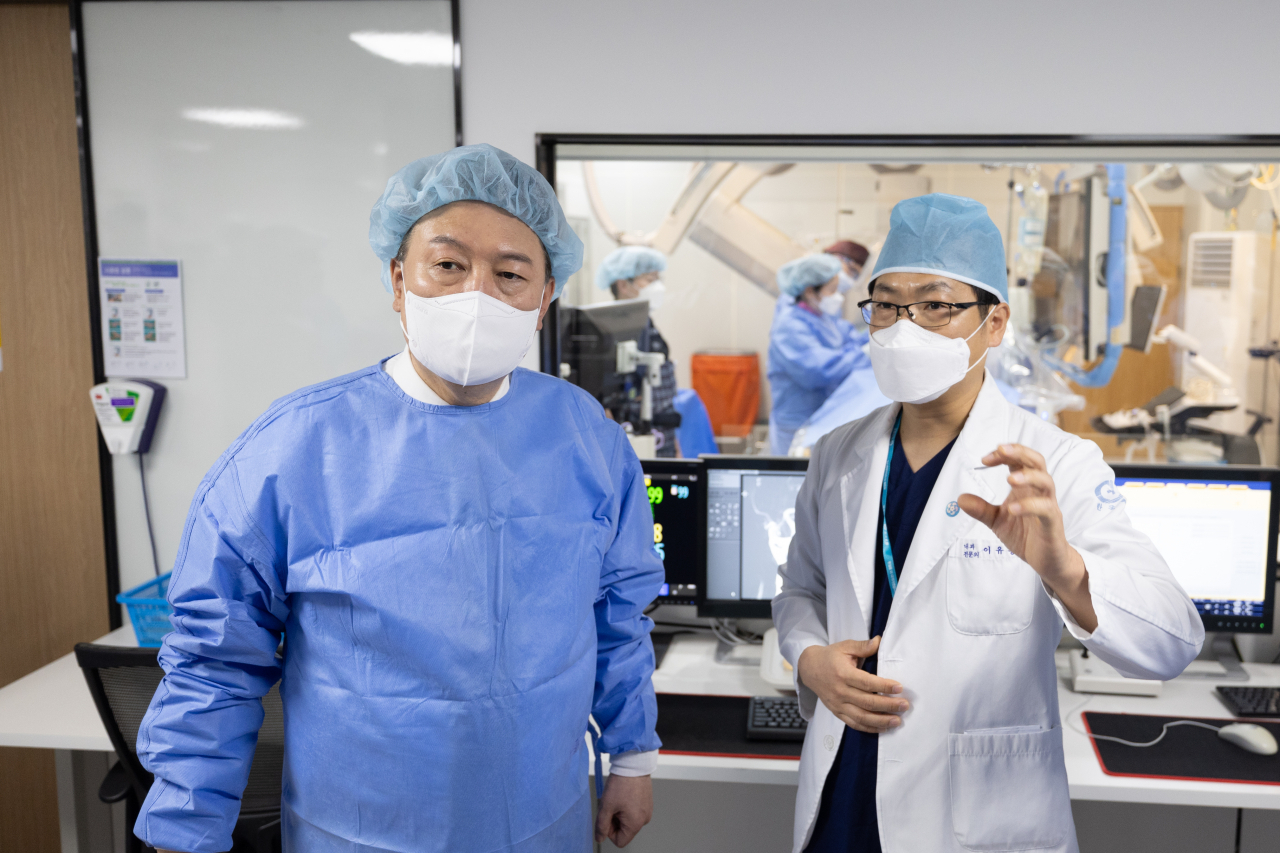 President Yoon Suk Yeol (left) visits a secondary hospital in Cheongju, North Chungcheong Province, on Tuesday, (Presidential Office)