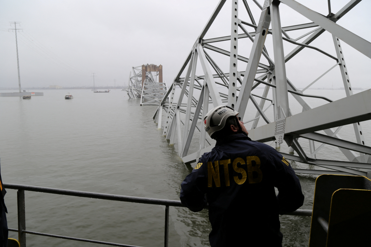 미국 교통안전위원회(NTSB) 직원이 27일(현지시간) 미국 메릴랜드주 볼티모어에서 프랜시스 스콧 키 다리를 들이받고 무너진 화물선 달리호를 바라보고 있다.