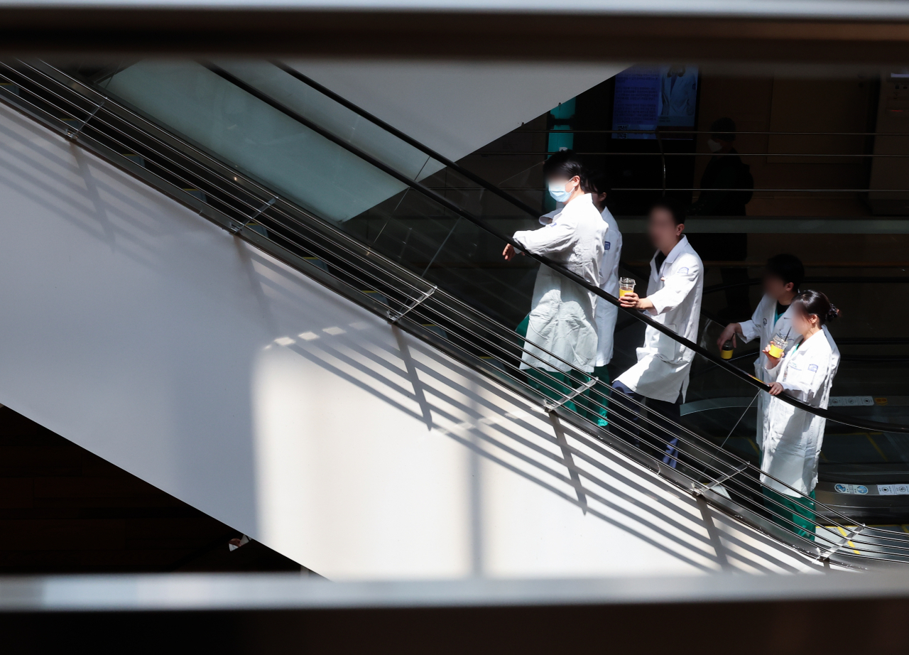 Amid prolonged tension between medical circles and the government, doctors move at a major general hospital in Seoul Thursday. (Yonhap)