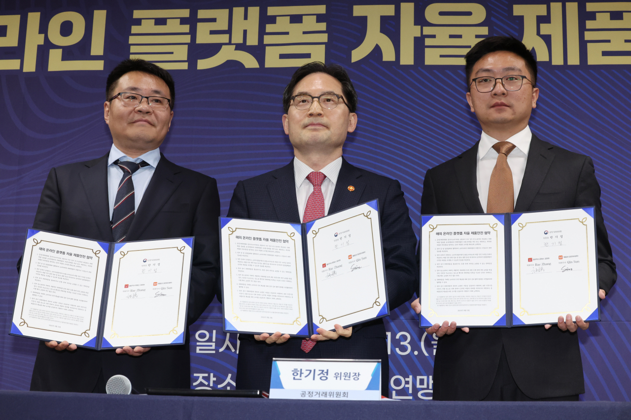 테무의 한국법인인 웨일코 코리아 퀸선 대표이사(왼쪽부터), 한기정 공정거래위원장, 레이 장 알리익스프레스 한국 대표가 13일 오후 서울 용산구 한국소비자연맹에서 열린 해외 온라인 플랫폼 자율 제품안전 협약식에서 협약서에 서명한 뒤 기념촬영하고 있다. [연합]