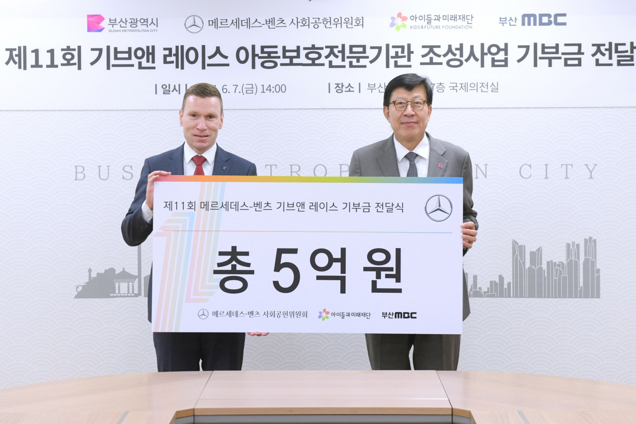 마티아스 바이틀(왼쪽부터) 메르세데스-벤츠 사회공헌위원회 의장과 박형준 부산광역시 시장이 지난 7일 부산광역시 연제구 부산시청에서 ‘제11회 메르세데스-벤츠 기브앤 레이스’를 통해 조성된 기부금 5억원을 부산시에 전달하고 기념 사진을 찍고 있다. [메르세데스-벤츠 제공]