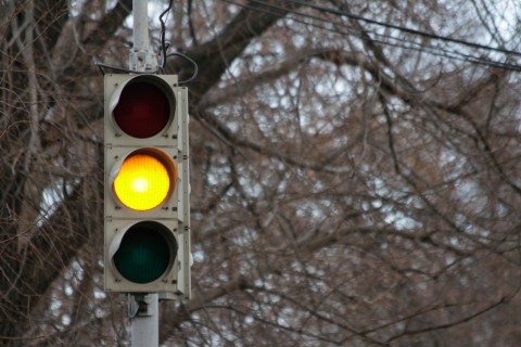 Yellow light just turned on. Should I go or stop?