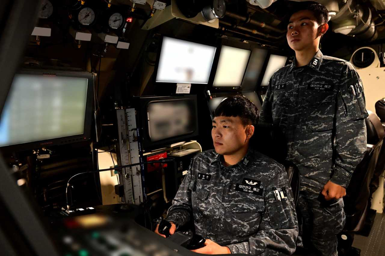 해군은 잠수함발사탄도미사일(SLBM) 탑재 3000t급 전략잠수함 안무함(SS-Ⅲ)이 전날 부산 인근 해상에서 가상의 적 잠수함과 수상함을 탐색·격멸하는 공격훈련과 적 지상 핵심표적을 타격하는 훈련을 실시했다고 12일 밝혔다. 안무함 승조원이 적 수상함 공격 훈련 중 긴급 잠항을 위해 잠수함을 움직이는 타기를 조종하고 있다. [해군 제공]