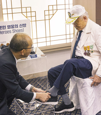 지난해 10월 국립서울현충원에서 송두식(오른쪽) 참전용사가 맞춤형 신발을 신는 모습 [한화에어로스페이스 제공]