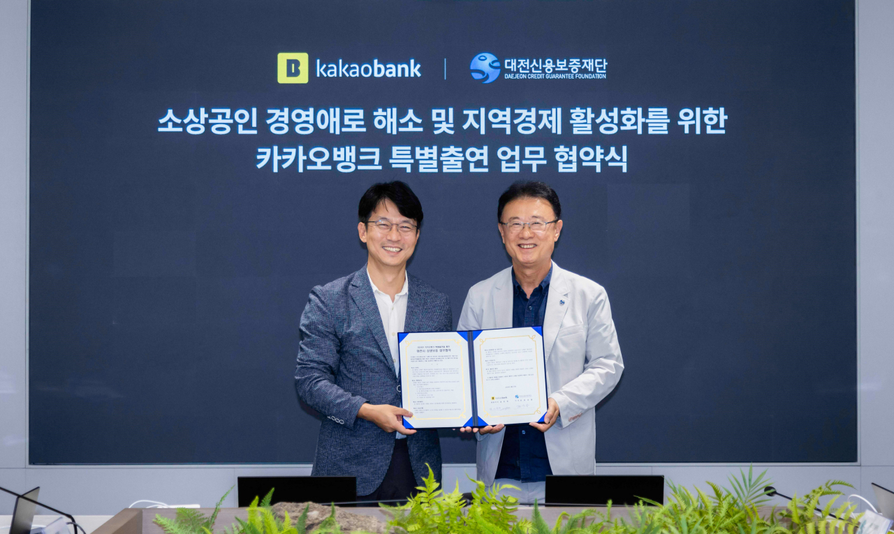 27일 카카오뱅크 판교오피스에서 진행된 업무협약식에 참석한 이형주(왼쪽) 카카오뱅크 최고비즈니스책임자와 정상봉(오른쪽) 대전신용보증재단 이사장이 기념촬영을 하고 있다.[카카오뱅크 제공]