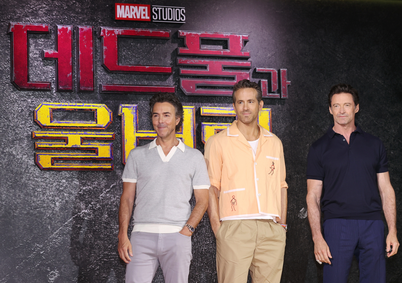 From left: Shawn Levy, Ryan Reynolds and Hugh Jackman pose at a press conference for their upcoming film, “Deadpool & Wolverine,” at Four Seasons Seoul on Thursday. (Yonhap)