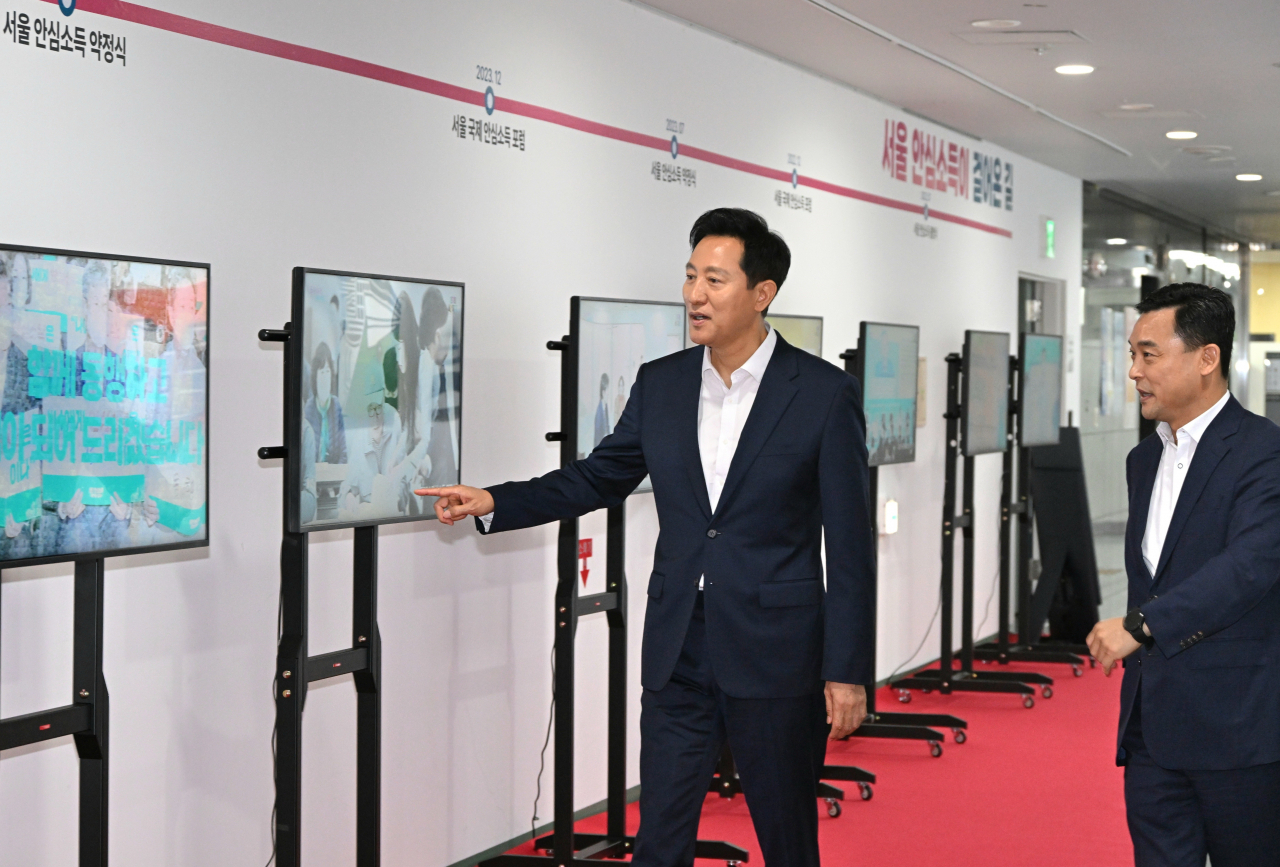 Seoul Mayor Oh Se-hoon tours a gallery showcasing the progress of the Seoul Safety Income initiative before attending the "Seoul Safety Income 2nd Anniversary Discussion Forum" held at City Hall on Thursday. (Seoul Metropolitan Government)