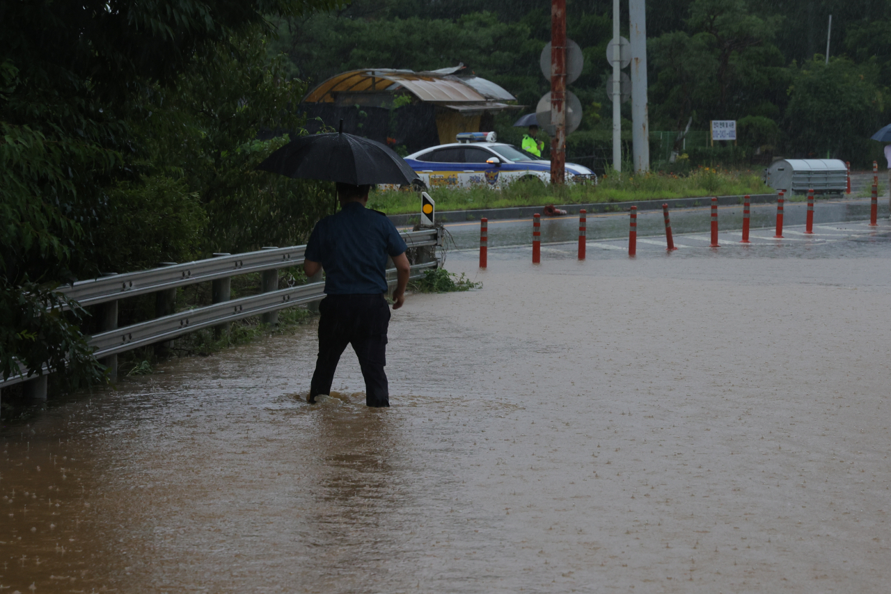 A road is inundated from torrential rain in Paju, north of Seoul, on Wednesday. (Yonhap)