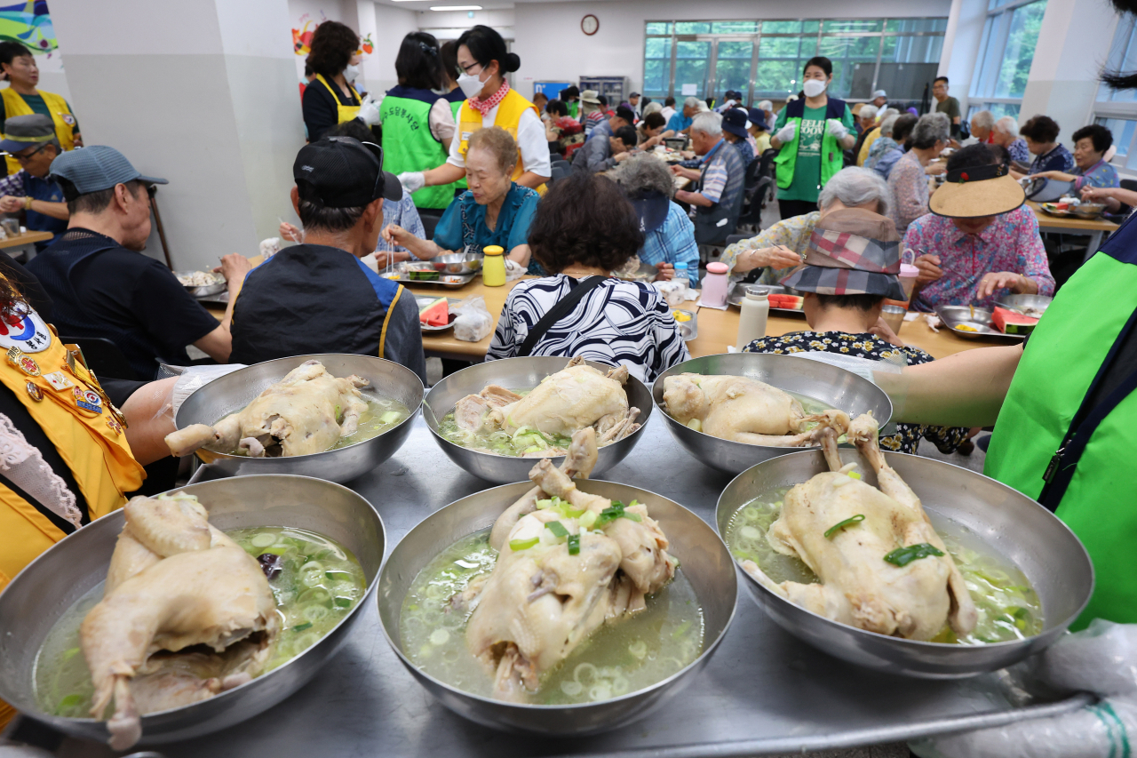 Senior citizens enjoy 'samgyetang,' a soup of chicken and ginseng with sticky rice, for free at a cafeteria of the regional Red Cross in Incheon, Monday. (Yonhap)