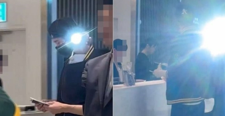 Actor Byeon Woo-seok, left, and security are seen allegedly flashing a light at the crowd. (Screen capture from X)