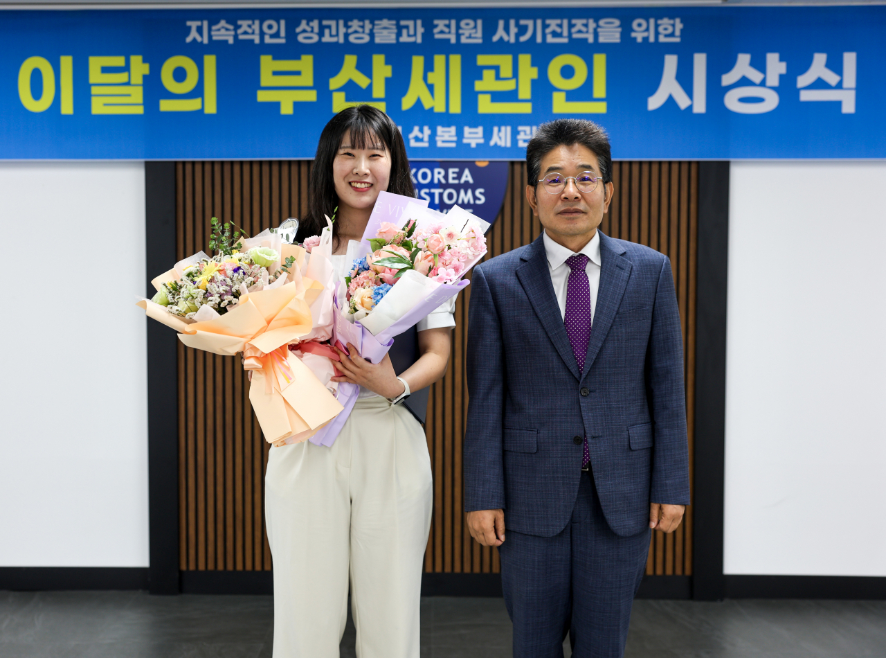 김용식 부산본부세관장(오른쪽)이 최신옥 주무관을 8월의 부산세관인으로 선정해 시상하고 있다. [사진=부산세관]