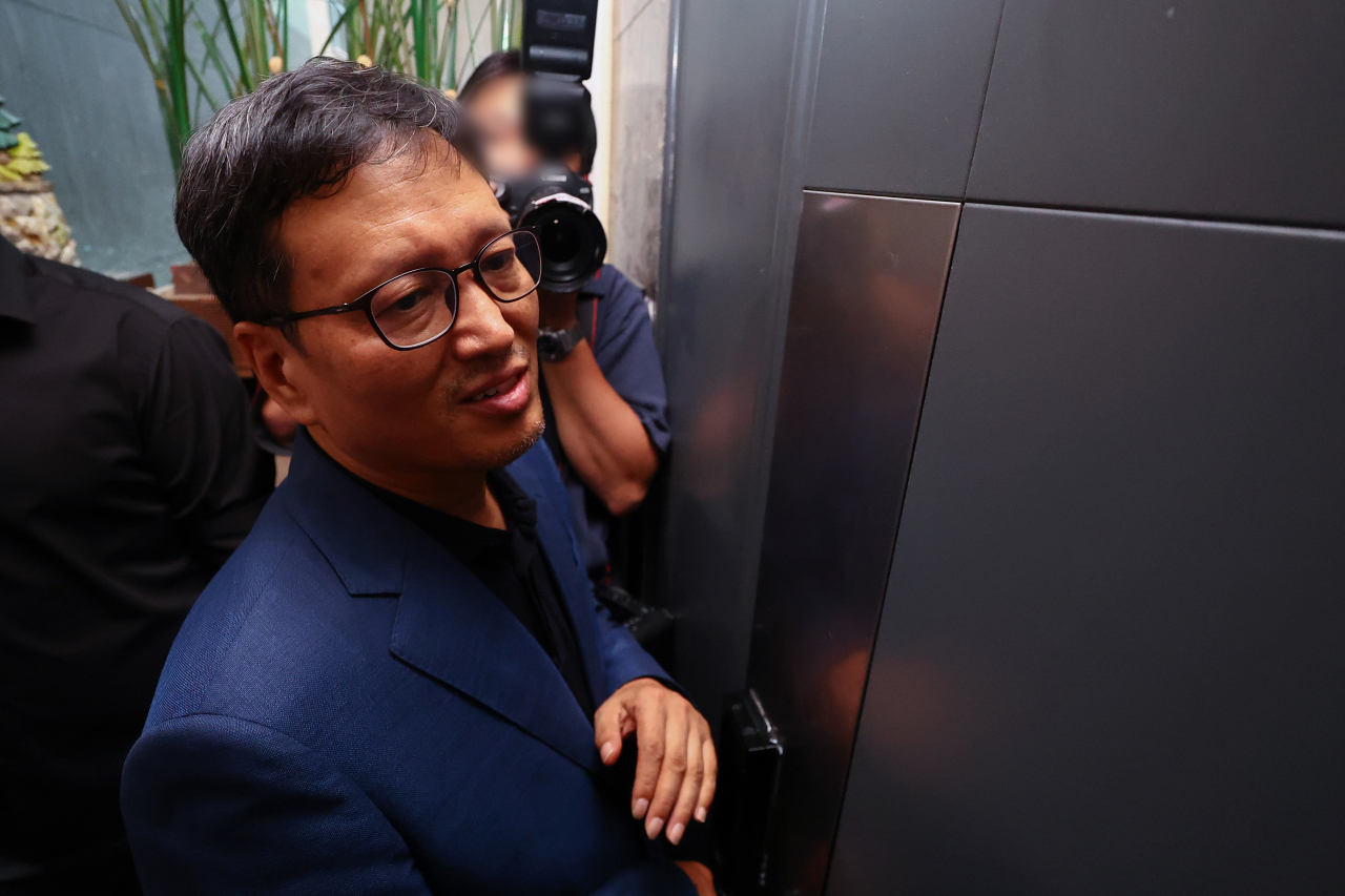 구영배 큐텐그룹 대표가 1일 검찰의 자택 압수수색 협조를 위해 자택 문을 열고 있다. [연합]