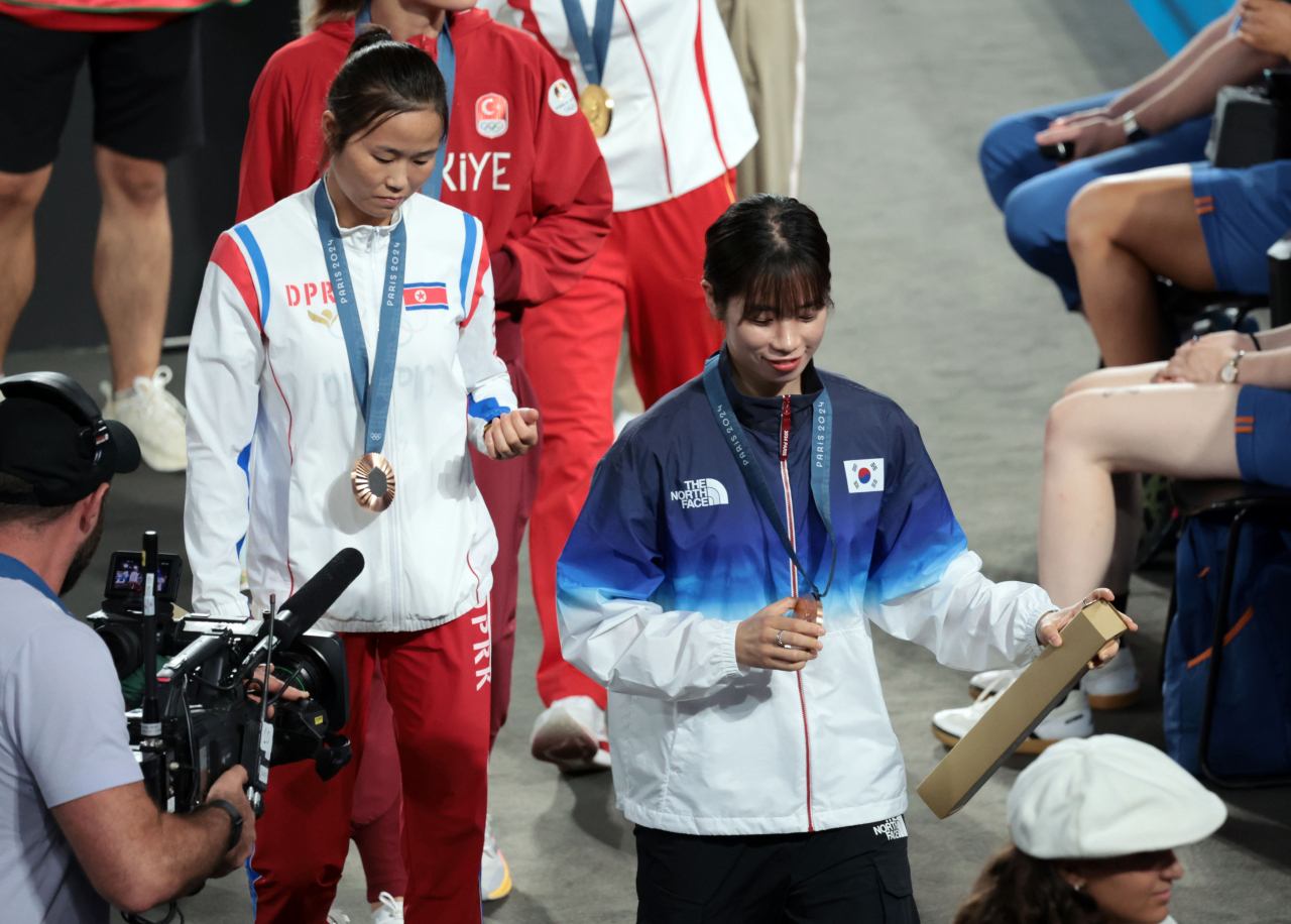 8일(현지시간) 프랑스 파리 롤랑가로스 경기장에서 열린 2024 파리 올림픽 복싱 여자 54㎏급에서 동메달을 획득한 한국 임애지와 북한 방철미가 시상식을 마친 뒤 경기장을 나서고 있다. [연합]