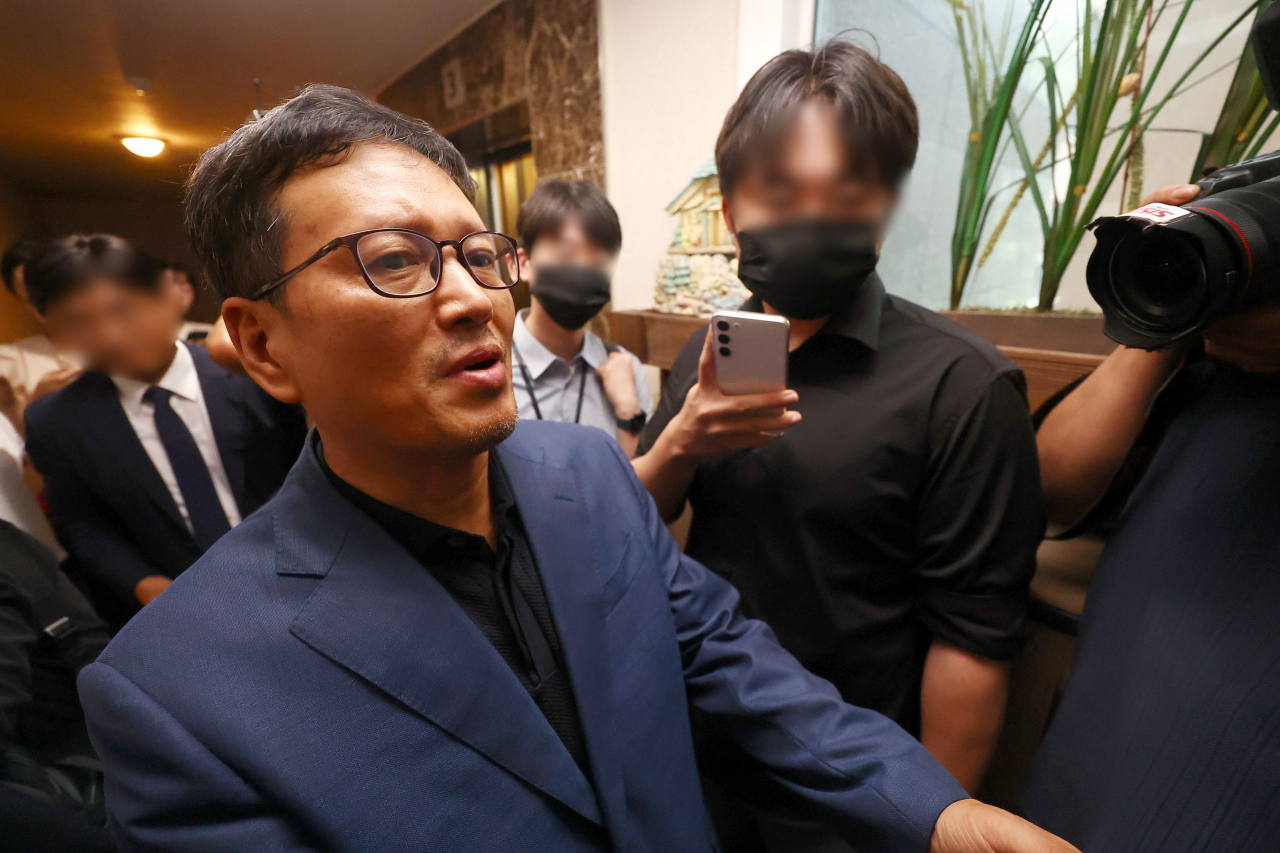 구영배 큐텐그룹 대표가 1일 검찰의 자택 압수수색 협조를 위해 검찰 관계자들과 함께 자택으로 들어가고 있다. [연합]