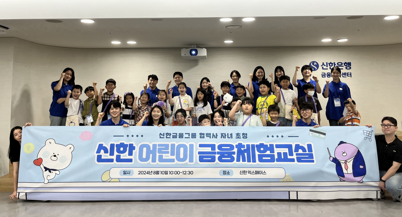 지난 10일 서울 중구 신한 익스페이스에서 실시된 ‘신한 어린이 금융체험교실’에 참석한 그룹사 협력업체 임직원들과 자녀들이 기념 촬영을 하고 있다.[신한금융그룹 제공]