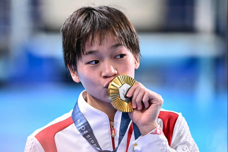 2024 파리올림픽에서 여자 10m 플랫폼에서 금메달을 딴 취안홍찬이 메달에 입을 맞추고 있다. [AFP연합]