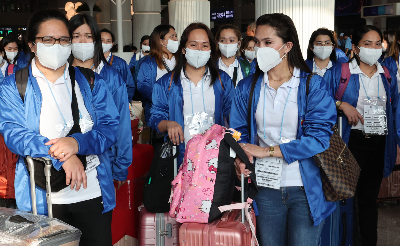 A hundred Filipina domestic helpers arrive at Incheon Airport on Aug. 6. (Pool photo via Yonhap)