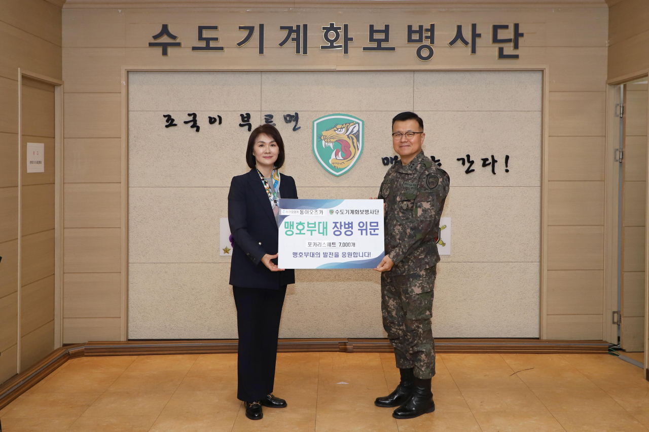 이진숙(왼쪽) 동아오츠카 전무가 김성구 수도기계화보병사단장와 포카리스웨트 전달식에서 기념사진을 촬영하고 있다. [동아오츠카 제공]