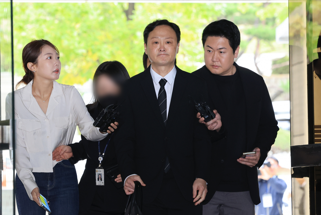 Qoo10 CEO Ku Young-bae (center) attends a hearing at the Seoul Central District Court on Thursday, as the court is to decide whether to issue an arrest warrant for him over a large-scale insolvency incident involving vendors on his e-commerce platforms. (Yonhap)