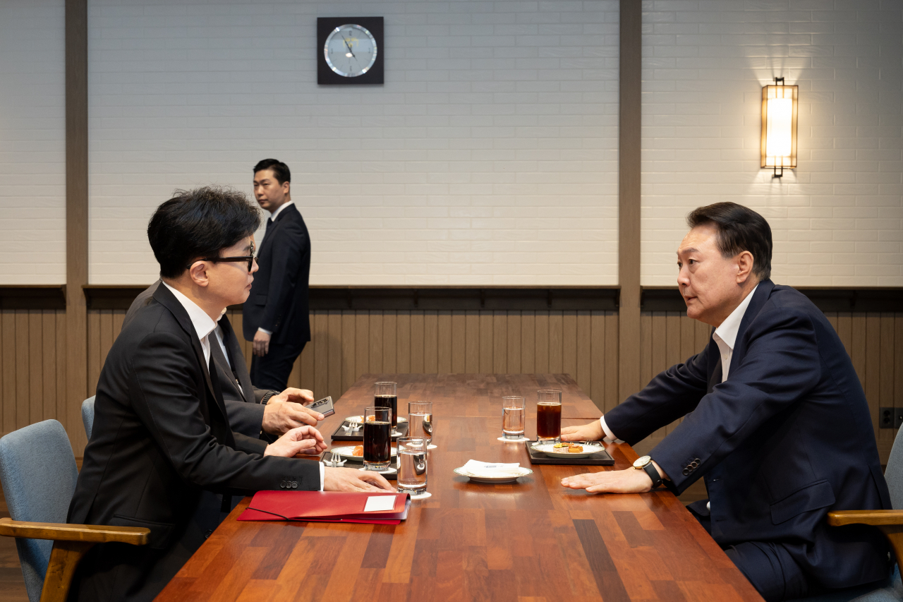 윤석열 대통령이 21일 서울 용산 대통령실 앞 파인그라스에서 국민의힘 한동훈 대표를 만나 대화하고 있다. [연합]
