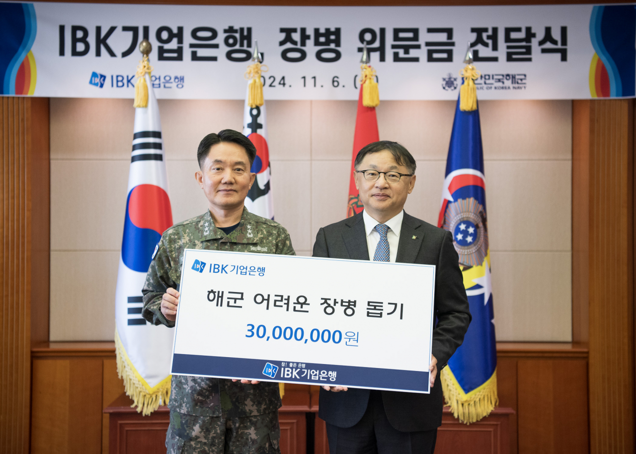 6일 해군 재경근무지원대대에서 열린 위문금 전달식에서 유일광(오른쪽) IBK기업은행 개인고객그룹 부행장과 김인호 해군 인사참모부장이 기념촬영을 하고 있다. [IBK기업은행 제공]