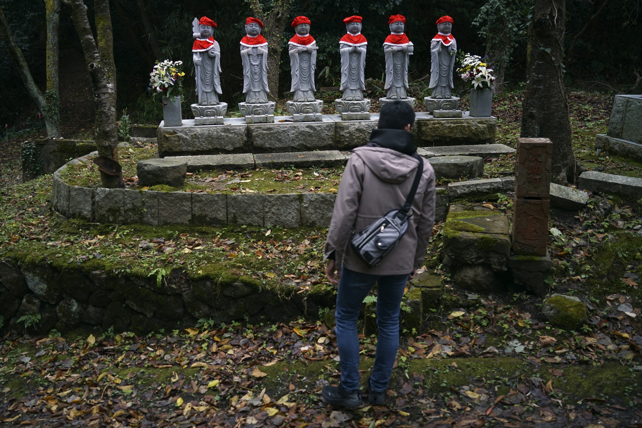 Stone statues are placed near the site of former Fourth Souai Dormitory in memory of the mine workers from the Korean Peninsula, in Sado, Niigata prefecture on Sunday. (AP)
