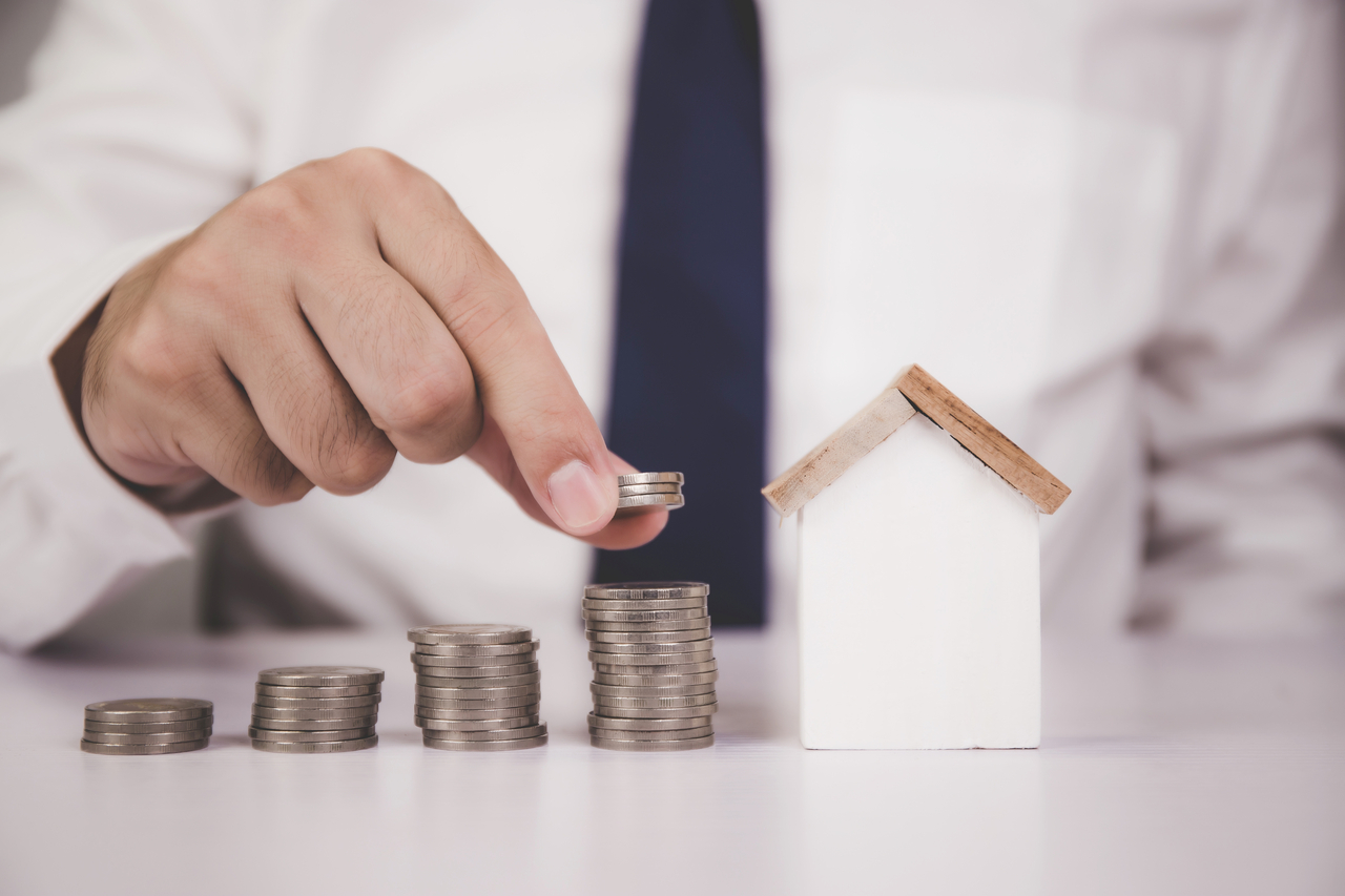 Hands of businessman and stack of coin with saving money for real estate and success, finance and investment, insurance home, deposit and property, residential and financial, business concept.