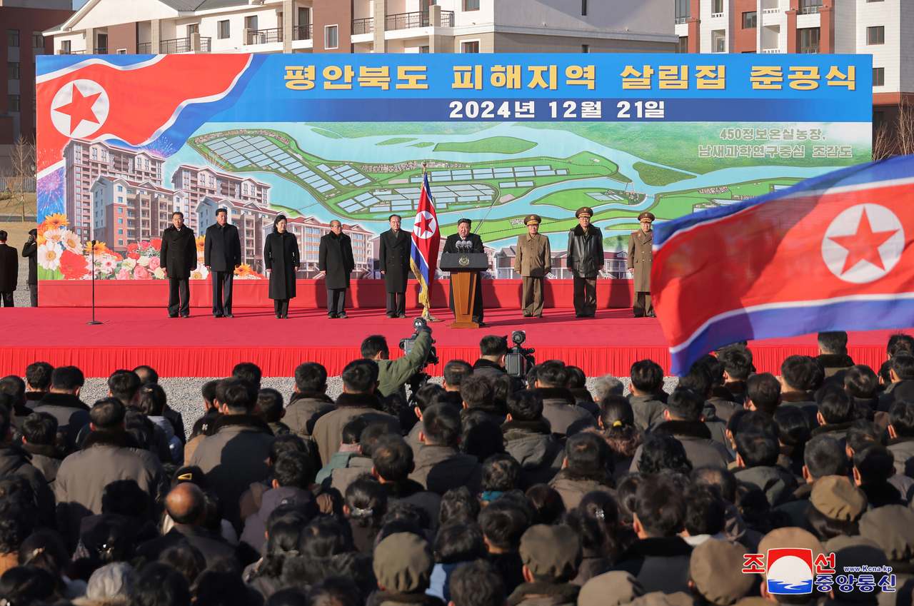 This photo, published by the Korean Central News Agency on Sunday, shows a ceremony held the previous day to mark the completion of rebuilt houses destroyed by floods in July.  (Yonhap)