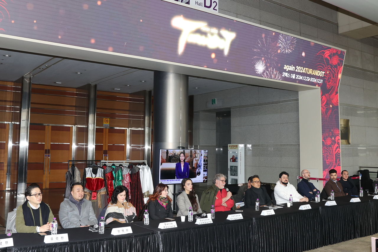 The cast and staff of Again 2024 Turandot pose for photos after a press conference at Coex on Dec. 17. (Yonhap)