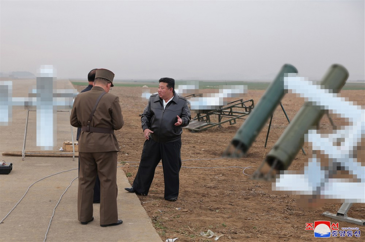 North Korean leader Kim Jong-un, right, inspects a performance test of suicide drones, produced by an affiliated institute of the Unmanned Aerial Technology Complex and businesses, on Nov. 14, in this file photo provided by the North's official Korean Central News Agency. Yonhap