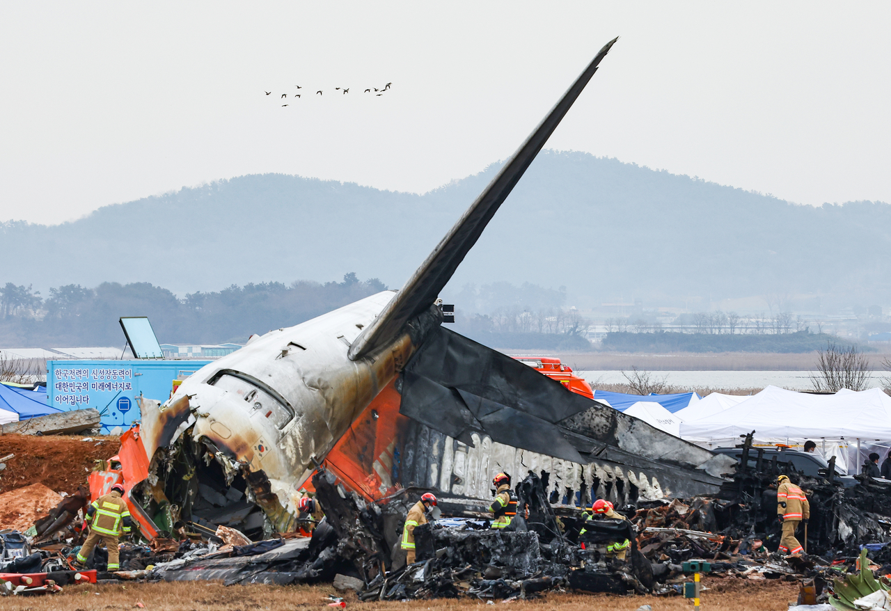 The scene of the collision and explosion accident involving a Jeju Air passenger plane at Muan International Airport in Muan County, South Jeolla Province, on Monday. (Yonhap)