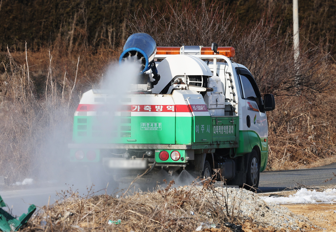 This file photo, taken on Dec. 27, 2024, shows a vehicle spraying disinfectant along a road in Yeoju, Gyeonggi Province, after bird flu broke out at an egg farm in the area. (Yonhap)