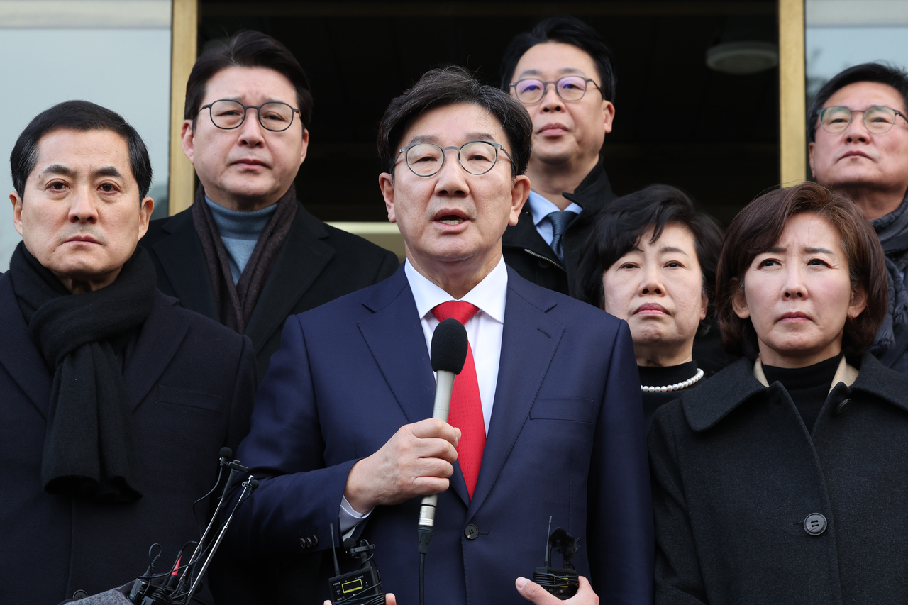 The ruling People Power Party lawmakers including floor leader Kweon Seong-dong (center) speaks to reporters at the Constitutional Court of Korea in Seoul on Monday. (Yonhap)