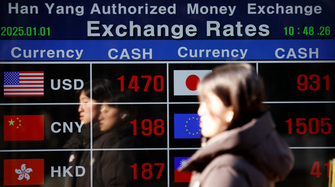 The exchange rates of the Korean won against other currencies are seen on a billboard of a money exchange in central Seoul on Jan. 1.