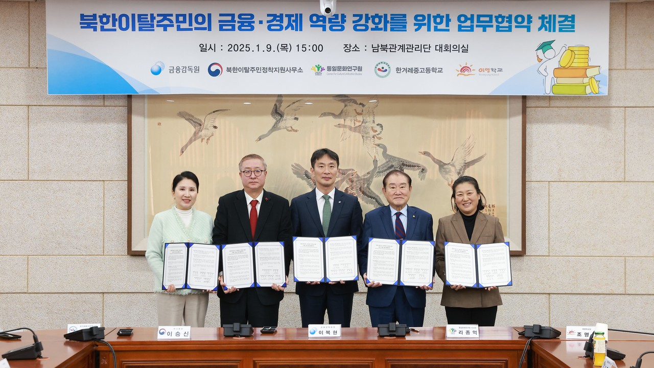 이복현(가운데) 금융감독원장이 지난 9일 서울 종로구 남북관계관리단에서 북한이탈주민의 금융·경제 역량 강화를 위한 다자간 업무협약을 체결한 뒤 관계자들과 기념촬영을 하고 있다.  [금융감독원 제공]