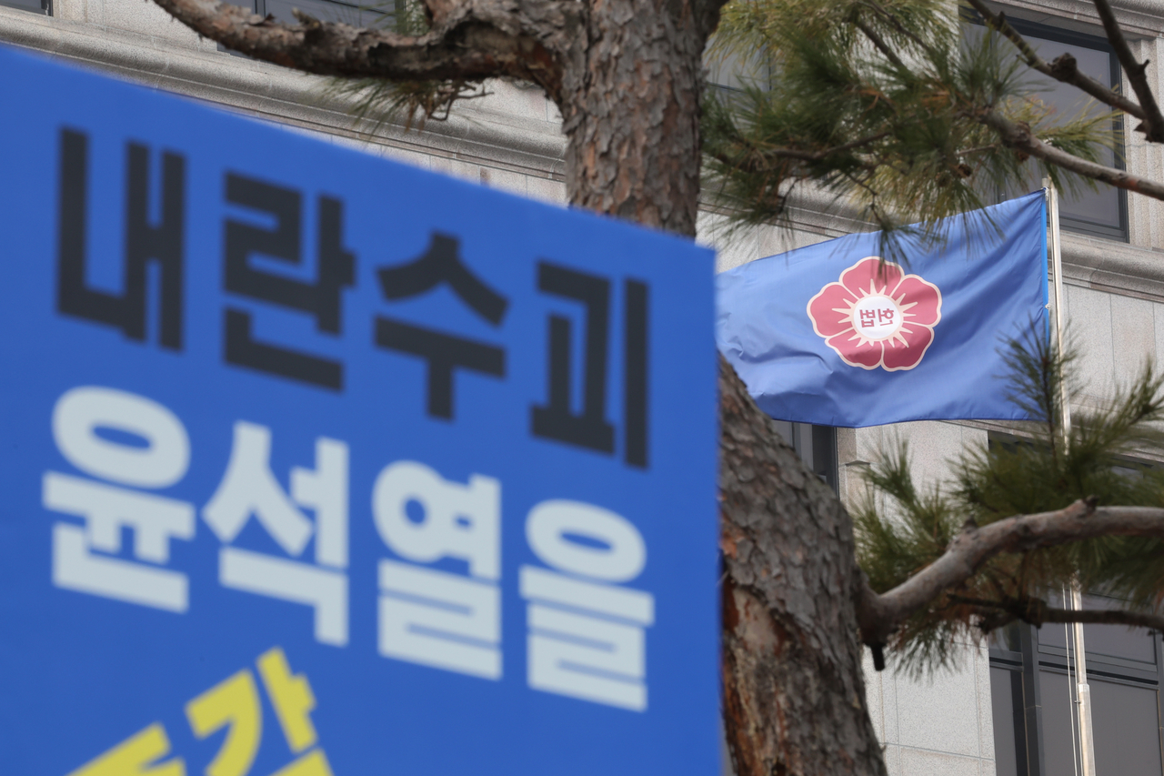 A sign calling for the immediate impeachment of suspended President Yoon Suk Yeol on charges of leading an insurrection is seen in front of the Constitutional Court of Korea in Seoul on Wednesday. (Yonhap)