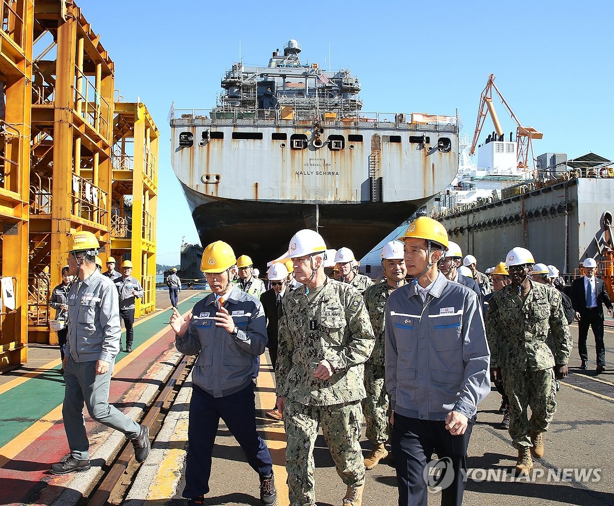 This file photo shows Adm. Steve Koehler (2nd from right, front row), commander of the US Pacific Fleet, visiting the South Korean shipbuilder's shipyard on the country's southeastern island city of Geoje on Oct. 24, 2024, where USNS Wally Schirra, a US Navy cargo ship, has received maintenance services under a deal between Hanwha and the US Navy. (Hanwha Ocean Co.)
