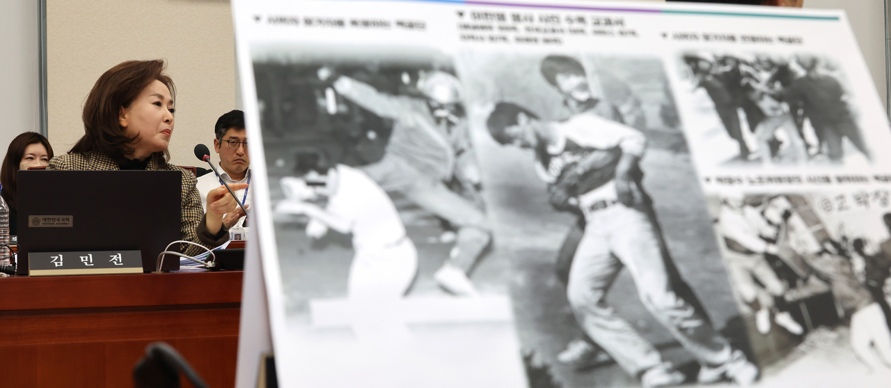 국민의힘 김민전 의원이 17일 국회 교육위원회에서 열린 AI 디지털교과서 검증 청문회에서 ‘백골단’ 회견과 관련해 의견을 피력하는 동안 야당 의원이 민주화 운동 시위를 폭력으로 진압하는 백골단 사진을 보여주고 있다.
김 의원은 윤석열 대통령 체포 반대 집회에 참가하며 ‘백골단’ 명칭을 사용한 ‘반공청년단’의 국회 기자회견을 주선했다. [연합]
