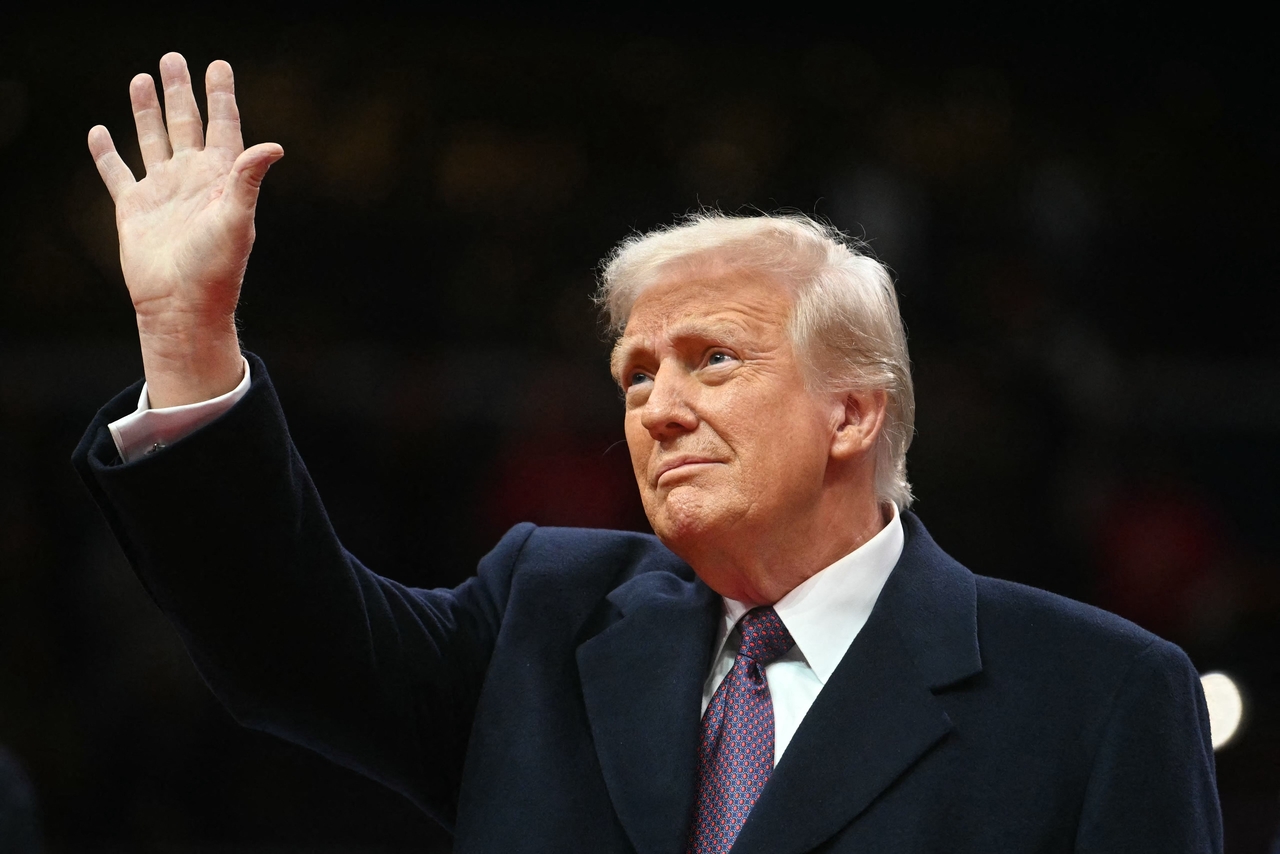 US President Donald Trump waves as he arrives at the inaugural parade inside Capitol One Arena in Washington, DC, on Monday. (AFP-Yonhap)