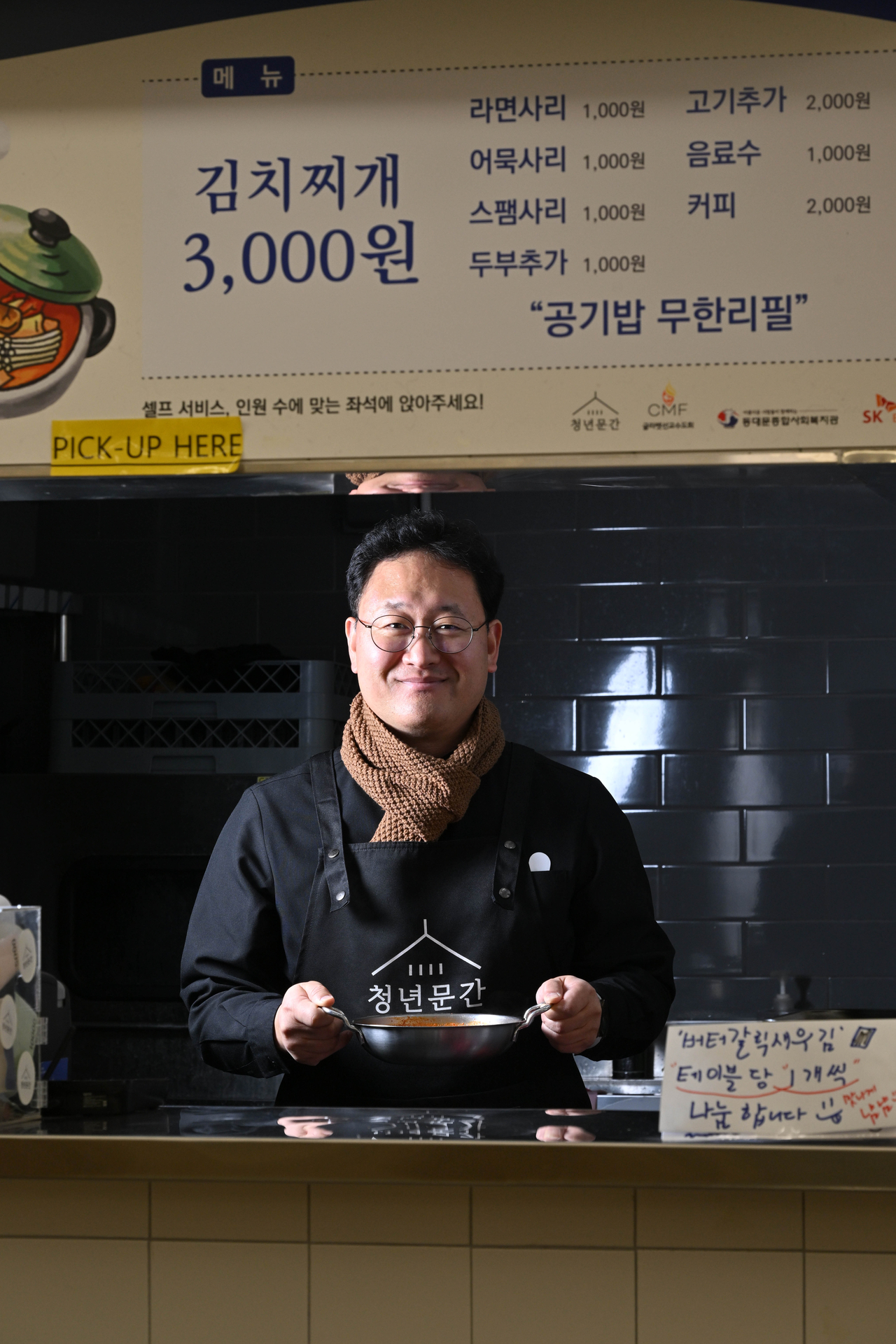 Catholic priest Gabriel Lee Mun-su poses for a photo at his kimchi jjigae restaurant, Youth Mungan in Seoul, ahead of his interview with The Korea Herald on Dec. 16. (Im Se-jun/The Korea Herald)