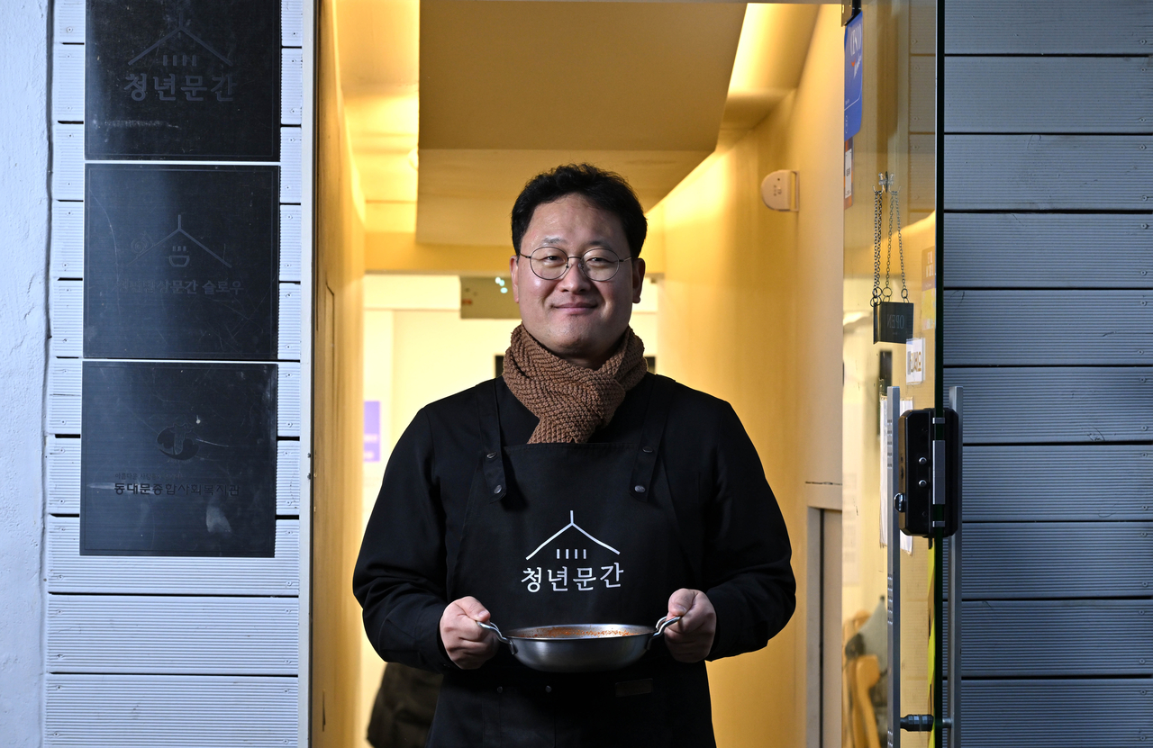 Catholic priest Gabriel Lee Mun-su poses for a photo at his kimchi jjigae restaurant, Youth Mungan in Seoul, ahead of his interview with The Korea Herald on Dec. 16. (Im Se-jun/The Korea Herald)